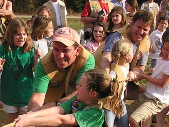 Daughters and their fathers during a game of tug of war