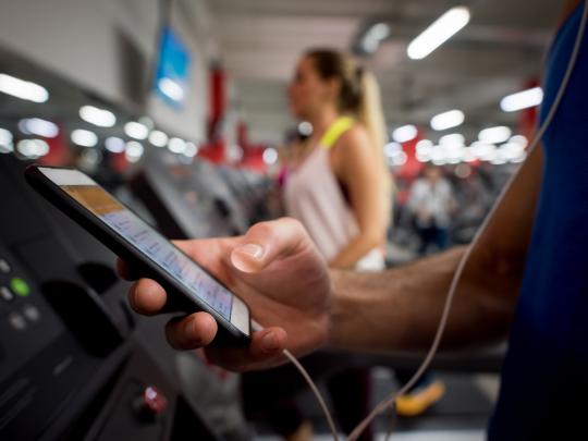 Man uses app in fitness center