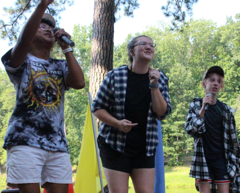 3 children sing outdoor talent show contest summer day camp
