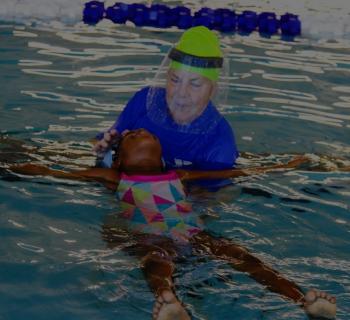 swimmer_and_instructor.jpg Swim instructor helps swimmer float