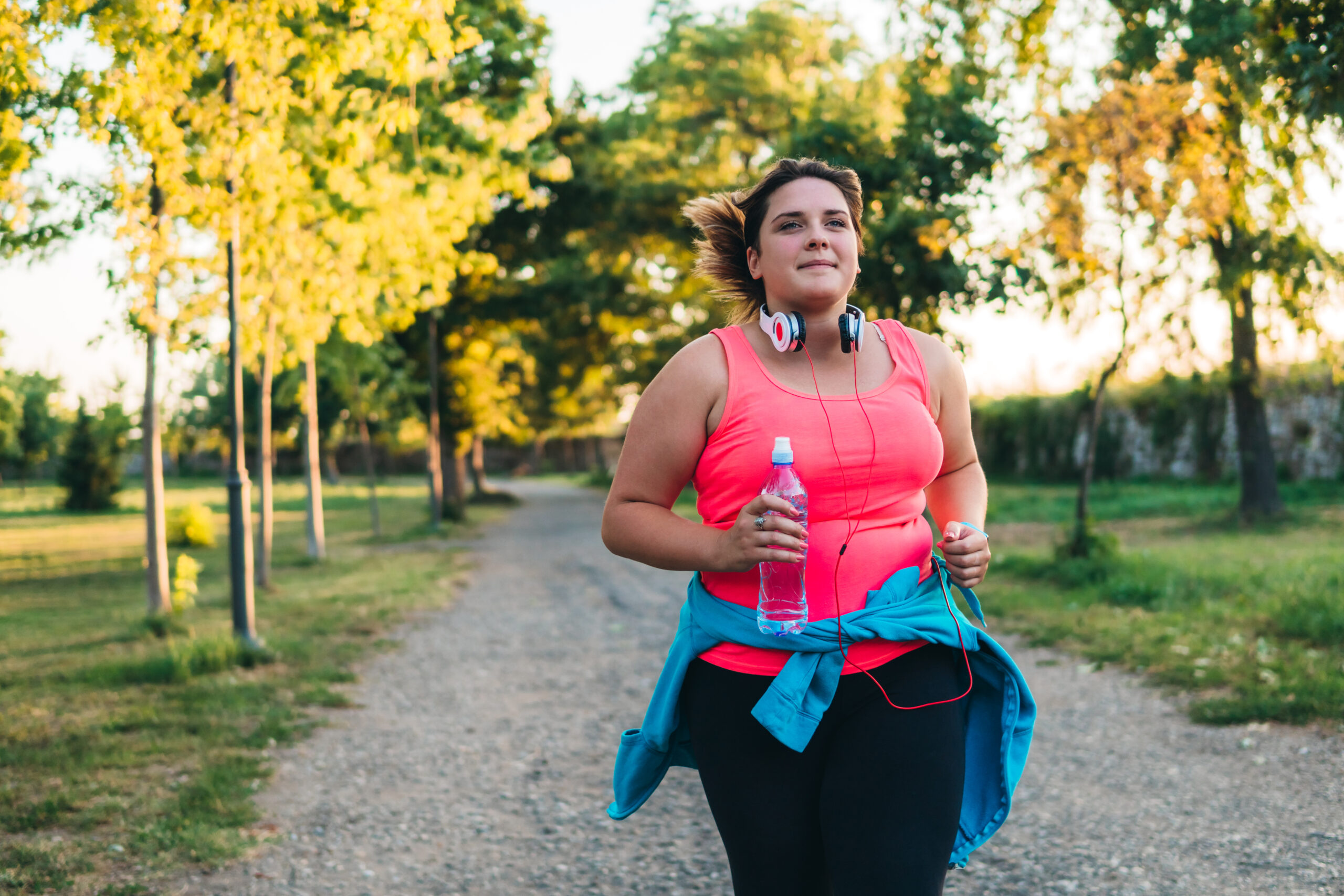 Young woman running in a public park.